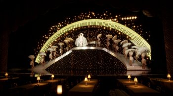 Movie still from “Behind the Candelabra” (2013), directed by Steven Soderbergh – A stage with a piano and a crowd of people holding umbrellas; Extreme Wide shot, High angle