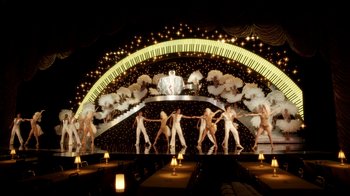 Movie still from “Behind the Candelabra” (2013), directed by Steven Soderbergh – A group of men are performing a dance on a stage; Extreme Wide shot, High angle