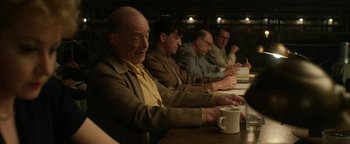 Movie still from “Being the Ricardos” (2021), directed by Aaron Sorkin – A group of people sitting at a table with cups; Medium shot, Over the shoulder angle