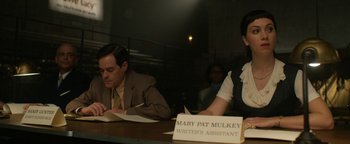 Movie still from “Being the Ricardos” (2021), directed by Aaron Sorkin – Two people sitting at a table with papers and pens; Medium shot, Low angle