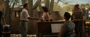 Movie still from “Being the Ricardos” (2021), directed by Aaron Sorkin – A man and a woman shaking hands over a piano; Medium shot, Over the shoulder angle