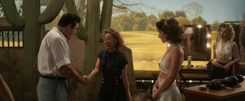 Movie still from “Being the Ricardos” (2021), directed by Aaron Sorkin – Two women and a man are shaking hands; Medium shot, Over the shoulder angle