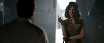 Movie still from “Being the Ricardos” (2021), directed by Aaron Sorkin – A woman holding a cigarette in front of a man; Medium shot, Over the shoulder angle