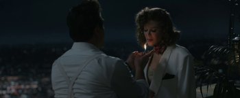 Movie still from “Being the Ricardos” (2021), directed by Aaron Sorkin – A man lighting a cigarette in front of a woman; Medium shot, Over the shoulder angle