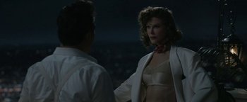 Movie still from “Being the Ricardos” (2021), directed by Aaron Sorkin – A man and a woman standing next to each other in front of a city skyline at night; Medium shot, Over the shoulder angle