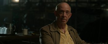 Movie still from “Being the Ricardos” (2021), directed by Aaron Sorkin – An older man wearing a yellow shirt and a brown jacket; Close Up shot, Over the shoulder angle