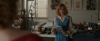 Movie still from “Being the Ricardos” (2021), directed by Aaron Sorkin – A woman standing in front of a counter holding papers; Medium shot, Over the shoulder angle