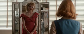 Movie still from “Being the Ricardos” (2021), directed by Aaron Sorkin – A woman in a red dress looking in the mirror; Medium shot, Over the shoulder angle