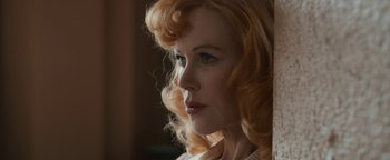 Movie still from “Being the Ricardos” (2021), directed by Aaron Sorkin – A person with blonde curly hair; Close Up shot, Over the shoulder angle