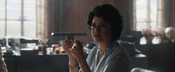 Movie still from “Being the Ricardos” (2021), directed by Aaron Sorkin – A woman holding a cigarette in her hands; Close Up shot, Over the shoulder angle