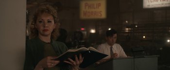 Movie still from “Being the Ricardos” (2021), directed by Aaron Sorkin – A woman reading a book in front of two men; Medium shot, Over the shoulder angle