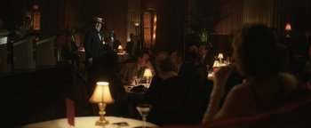 Movie still from “Being the Ricardos” (2021), directed by Aaron Sorkin – A group of people sitting at a table in a room; Wide shot, Over the shoulder angle