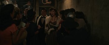 Movie still from “Being the Ricardos” (2021), directed by Aaron Sorkin – A group of people standing next to each other in a building; Medium shot, Over the shoulder angle