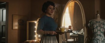 Movie still from “Being the Ricardos” (2021), directed by Aaron Sorkin – A woman holding a tray of food and a glass of orange juice; Medium shot, Low angle