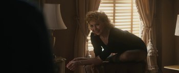 Movie still from “Being the Ricardos” (2021), directed by Aaron Sorkin – A woman in a black dress leaning on a couch; Medium shot, High angle