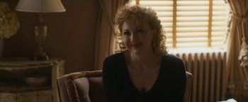 Movie still from “Being the Ricardos” (2021), directed by Aaron Sorkin – A woman sitting on a couch in front of a window; Close Up shot, Over the shoulder angle