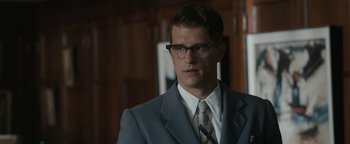 Movie still from “Being the Ricardos” (2021), directed by Aaron Sorkin – A man in a suit and tie standing in a room; Close Up shot, Over the shoulder angle