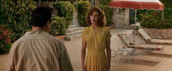 Movie still from “Being the Ricardos” (2021), directed by Aaron Sorkin – A woman in a yellow dress standing in front of a man; Medium shot, Over the shoulder angle