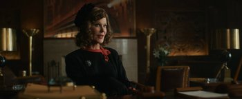 Movie still from “Being the Ricardos” (2021), directed by Aaron Sorkin – A woman sitting at a table in front of a painting; Medium shot, Over the shoulder angle