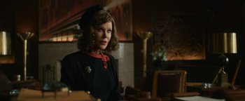Movie still from “Being the Ricardos” (2021), directed by Aaron Sorkin – A woman in a black dress and a red hat; Medium shot, Over the shoulder angle