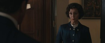 Movie still from “Being the Ricardos” (2021), directed by Aaron Sorkin – A woman standing in front of a door wearing a suit; Medium shot, Over the shoulder angle