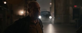 Movie still from “Being the Ricardos” (2021), directed by Aaron Sorkin – An older man standing in the middle of the street; Close Up shot, Over the shoulder angle