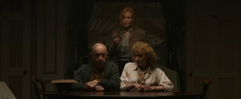 Movie still from “Being the Ricardos” (2021), directed by Aaron Sorkin – A group of people sitting at a wooden table; Medium shot, Low angle