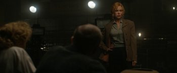 Movie still from “Being the Ricardos” (2021), directed by Aaron Sorkin – A woman standing in front of a man in a dark room; Medium shot, Over the shoulder angle