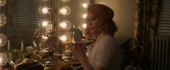 Movie still from “Being the Ricardos” (2021), directed by Aaron Sorkin – A woman with red curly hair is holding a mirror; Medium shot, Over the shoulder angle