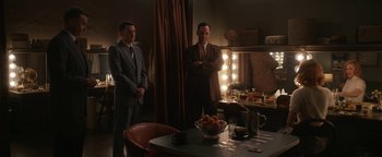 Movie still from “Being the Ricardos” (2021), directed by Aaron Sorkin – A couple of men standing next to each other in a room; Wide shot, High angle