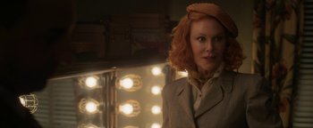 Movie still from “Being the Ricardos” (2021), directed by Aaron Sorkin – A woman with red curly hair standing in front of lights; Close Up shot, Over the shoulder angle