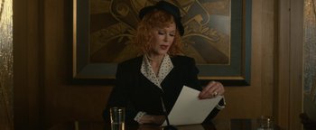 Movie still from “Being the Ricardos” (2021), directed by Aaron Sorkin – A woman sitting at a table looking at a piece of paper; Medium shot, Low angle