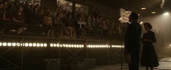 Movie still from “Being the Ricardos” (2021), directed by Aaron Sorkin – A group of people sitting in a room with lights on; Wide shot, High angle