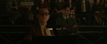 Movie still from “Being the Ricardos” (2021), directed by Aaron Sorkin – A man sitting at a piano in front of a crowd; Medium shot, Over the shoulder angle