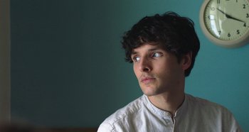 A young man with blue eyes looking up at the sky