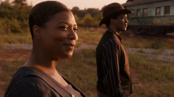Movie still from “Bessie” (2015), directed by Dee Rees – A woman standing next to a man on a field; Close Up shot, Over the shoulder angle