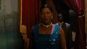 Movie still from “Bessie” (2015), directed by Dee Rees – A woman in a blue dress standing in front of a man; Medium shot, Over the shoulder angle