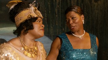 Movie still from “Bessie” (2015), directed by Dee Rees – Two women are dressed up and one is talking to another woman; Close Up shot, Over the shoulder angle