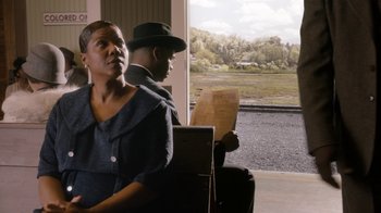 Movie still from “Bessie” (2015), directed by Dee Rees – A man and a woman sitting next to each other on a bench; Medium shot, Over the shoulder angle