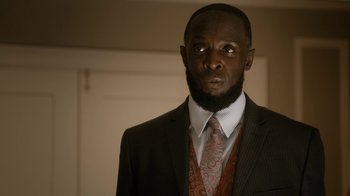 Movie still from “Bessie” (2015), directed by Dee Rees – A man in a suit and tie standing in front of a mirror; Close Up shot, Low angle