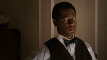 Movie still from “Bessie” (2015), directed by Dee Rees – A man wearing a vest and a bow tie; Close Up shot, Over the shoulder angle