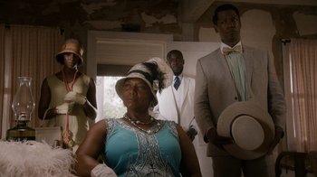 Movie still from “Bessie” (2015), directed by Dee Rees – A group of men and women standing in a room; Medium shot, Low angle