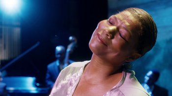 Movie still from “Bessie” (2015), directed by Dee Rees – A person with her eyes closed; Close Up shot, Over the shoulder angle