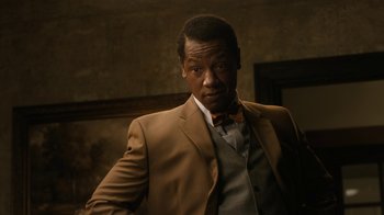 Movie still from “Bessie” (2015), directed by Dee Rees – A man wearing a suit and bow tie; Close Up shot, Over the shoulder angle