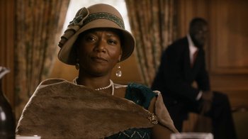 Movie still from “Bessie” (2015), directed by Dee Rees – An older woman wearing a brown hat and pearls; Close Up shot, Low angle