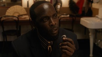 Movie still from “Bessie” (2015), directed by Dee Rees – A man in a suit and tie holding a wedding ring; Close Up shot, High angle