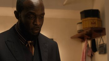 Movie still from “Bessie” (2015), directed by Dee Rees – A man in a suit and tie looking at the camera; Close Up shot, Low angle