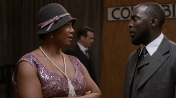 Movie still from “Bessie” (2015), directed by Dee Rees – A woman and a man are talking to each other; Medium shot, Over the shoulder angle