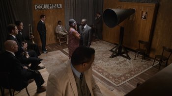 Movie still from “Bessie” (2015), directed by Dee Rees – A group of people standing in front of a camera; Wide shot, High angle
