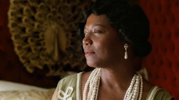 Movie still from “Bessie” (2015), directed by Dee Rees – An older black woman wearing a green dress and pearls; Close Up shot, Low angle